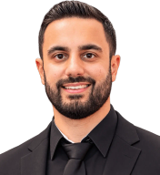 Ufuk Kaya, smiling, in a dark suit and tie